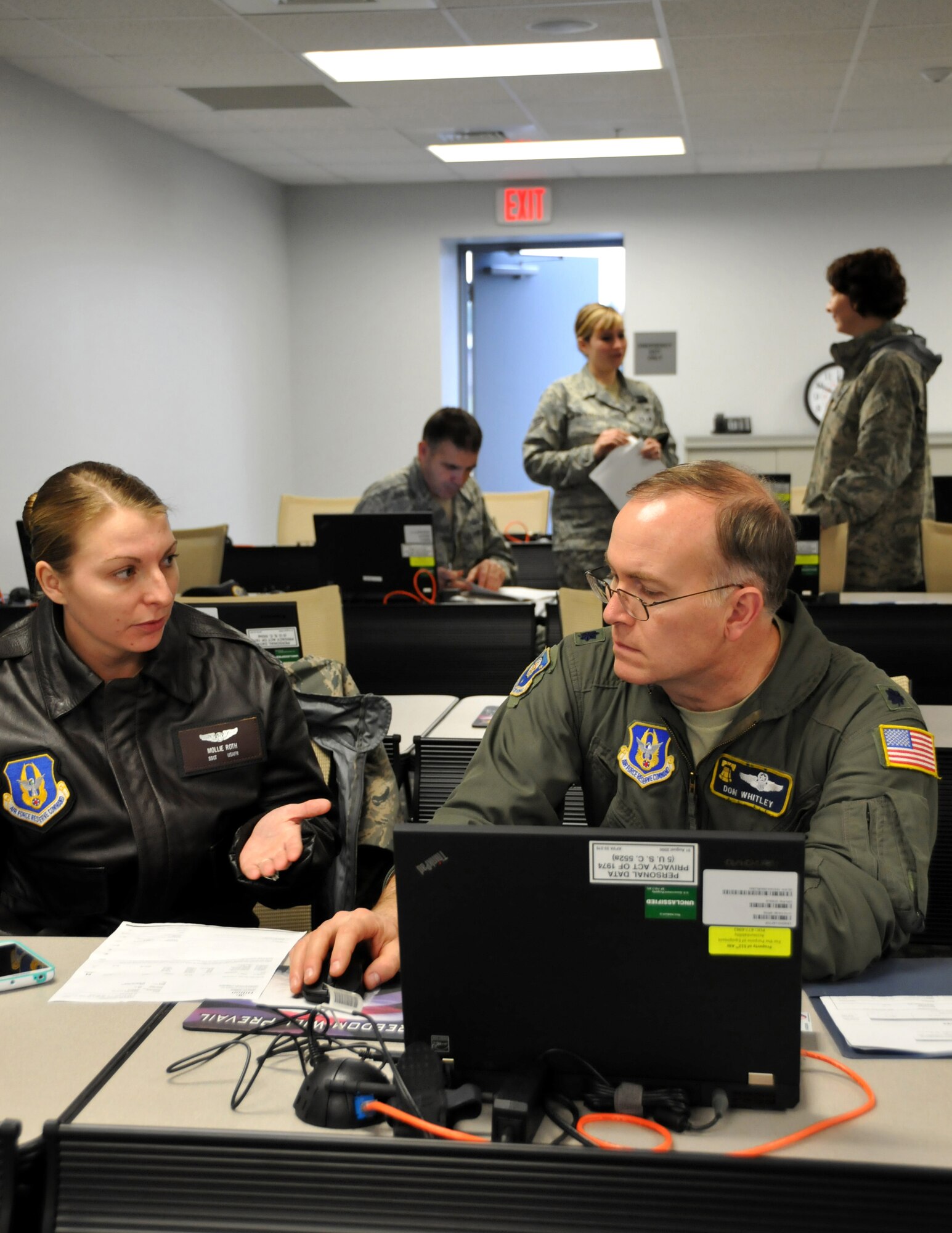 Staff Sgt. Mollie Roth, 326th Airlift Squadron member and travel voucher subject matter expert, navigates Lt. Col. Donald Whitley, 512th Airlift Wing, through the steps of filing a travel voucher in the Defense Travel System at a travel voucher lab, Dover Air Force Base, Del., Jan. 11, 2014. The lab was created in an effort to assist wing members to receive their travel pay faster and ensure timely government travel card payments. (U.S. Air Force photo/Staff Sgt. Cole Presley)