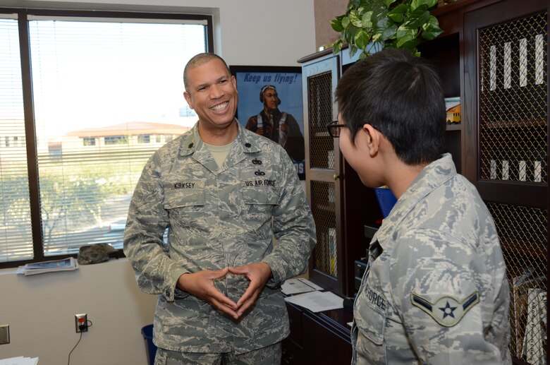 U.S. Air Force Lt. Col Allen Kirksey, 161st Air Refueling Wing chief of staff, mentors Airman Treva Begay, 161st Air Refueling Wing, knowledge operator, on the importance of being a leader and making the most of opportunities.  Colonel Kirksey is the 2014 Calvin C. Goode Lifetime Achievement award recipient for his exceptional commitment to the community. (Air National Guard photo by Senior Airman Rashaunda Williams)