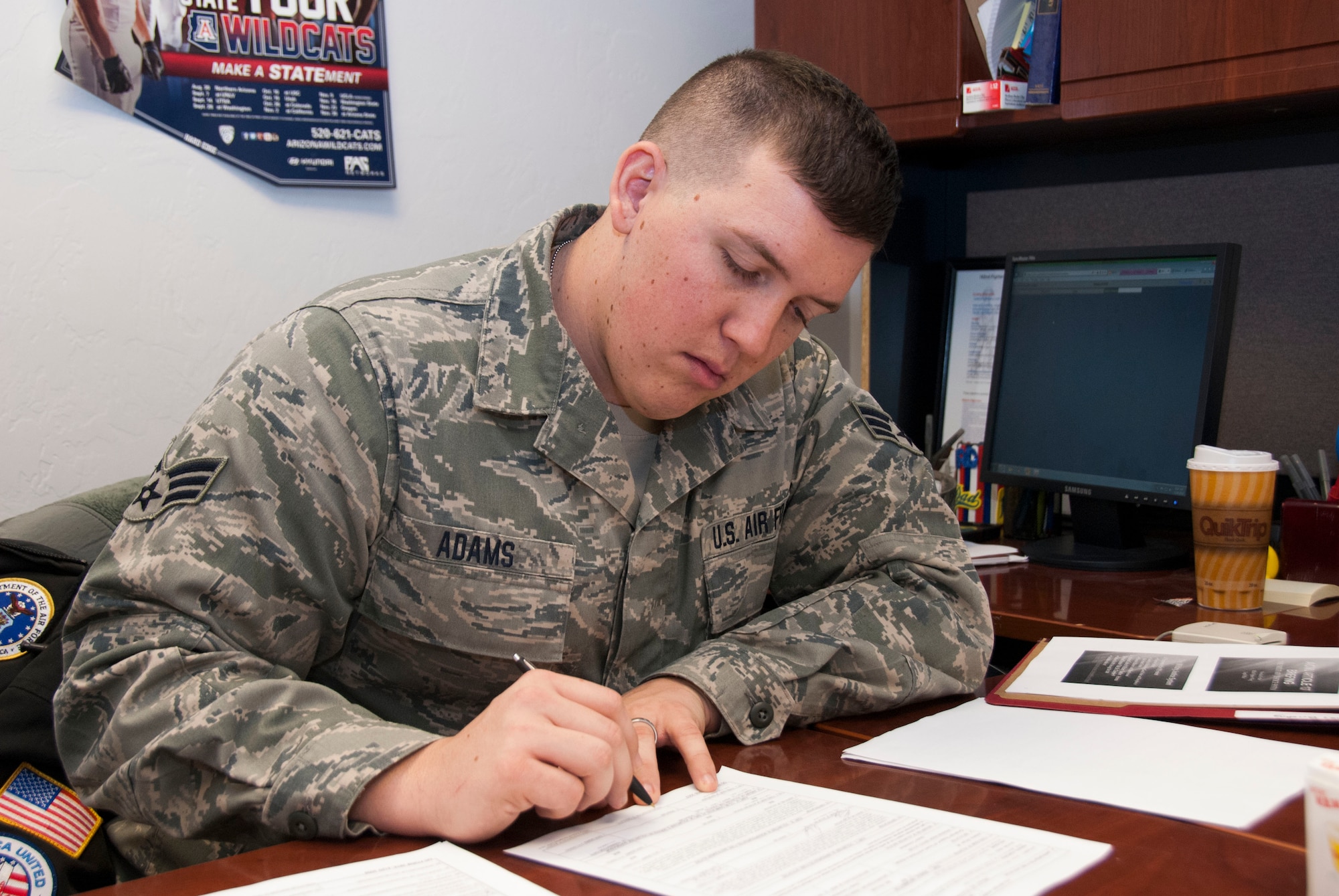Senior Airman Bryan Adams, a paralegal specialist with the 162nd Fighter Wing’s Judge Advocate General, reviews documents in the legal office. The JAG Corps here assists Air Guard personnel by meeting their pre-deployment legal needs while serving in a direct support function to the wing commander. Though JAG is not permitted to provide advice on criminal or certain civil matters, the 162nd Fighter Wing’s legal support team highly encourages Airmen to visit their office so they can steer them in the right direction by providing referrals. (U.S. Air National Guard photo by Staff Sgt. Erich B. Smith/Released)