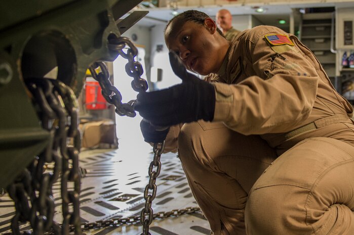 Staff Sgt. Orial Christopher, 817th Expeditionary Airlift Squadron loadmaster, secures cargo in a C-17A Globemaster III at Kandahar Airfield, Afghanistan,  Jan. 3, 2014. Christopher is deployed from Joint Base Charleston, S.C., in support of the 405th  Air Expeditionary Group.  The 405th AEG supports U.S. Central Command's Deployment and Distribution Operation Center, a strategically located air, land and sea logistics hub, playing a critical role in the U.S. departure from Afghanistan. (U.S. Air Force photo by Staff Sgt. Stephany Richards)