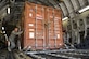 Tech. Sgt. James Schenck, 405th Logistics Readiness Squadron cargo and special handling noncommissioned officer in charge, pushes a container express box off a C-17A Globemaster III and onto a K-loader at an undisclosed location in Southwest Asia, Dec. 31, 2013. Schenck is deployed from Peterson Air Force Base, Colo., and is assigned to the 405th Air Expeditionary Group. (U.S. Air Force photo by Staff Sgt. Stephany Richards) 
