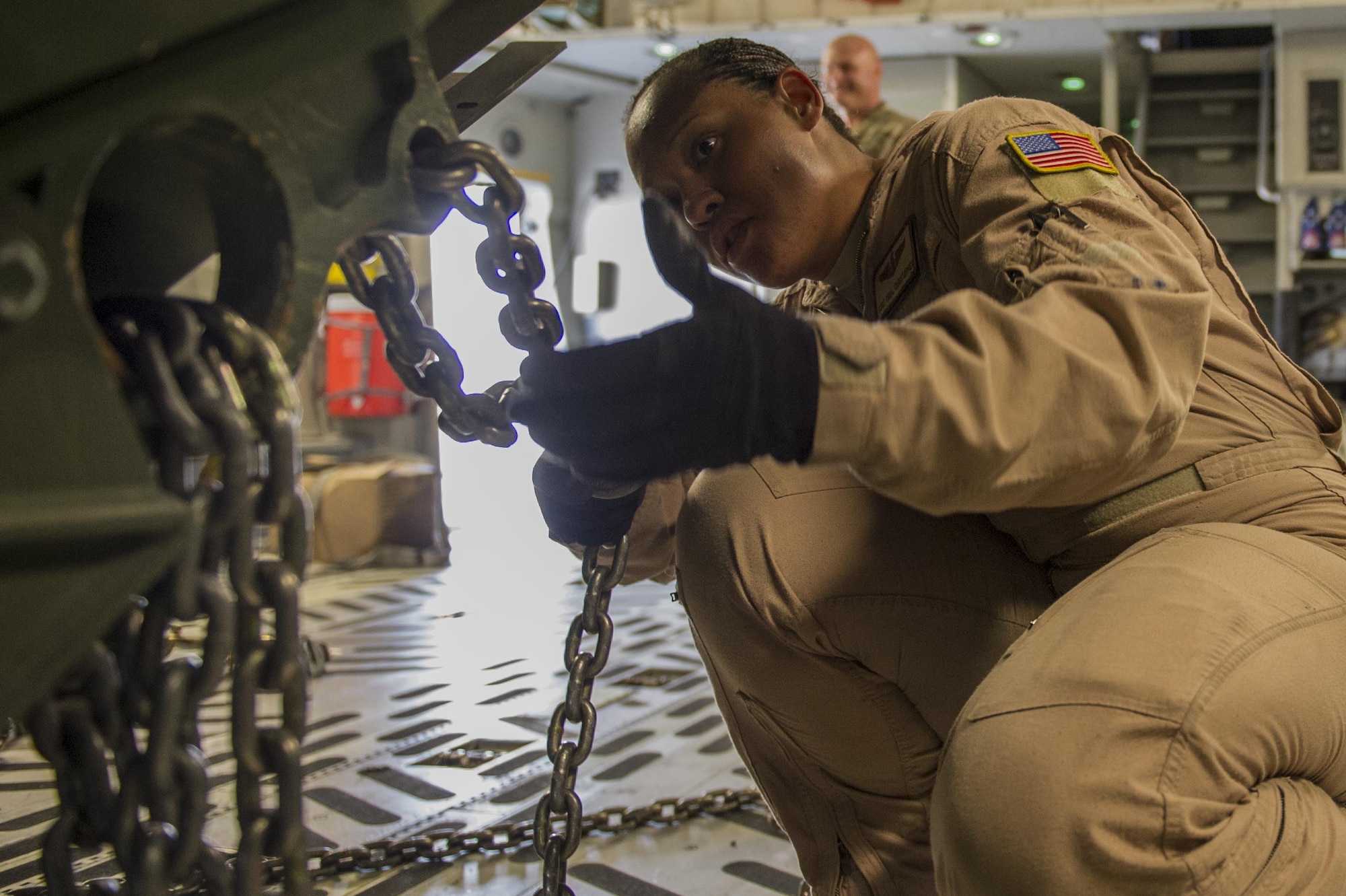 Staff Sgt. Orial Christopher, 817th Expeditionary Airlift Squadron loadmaster, secures cargo in a C-17A Globemaster III at Kandahar Airfield, Afghanistan, Jan. 3, 2014. Christopher is deployed from Joint Base Charleston, S.C., in support of the 405th Air Expeditionary Group. The 405th AEG supports U.S. Central Command's Deployment and Distribution Operation Center, a strategically located air, land and sea logistics hub, playing a critical role in the U.S. departure from Afghanistan. (U.S. Air Force photo by Staff Sgt. Stephany Richards) 
