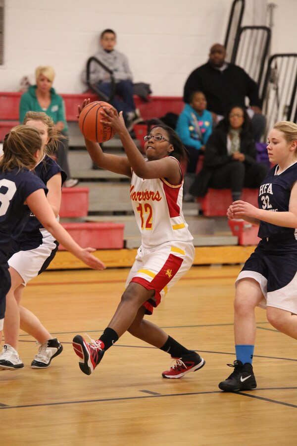 Jakeria, a Quantico guard, fights to maintain the ball during a basketball game against the Holy Family Academy Vendeens during a game at Quantico Middle/High School on Jan. 7, 2014. The Lady Warriors won their seventh game of the season 61-50. 