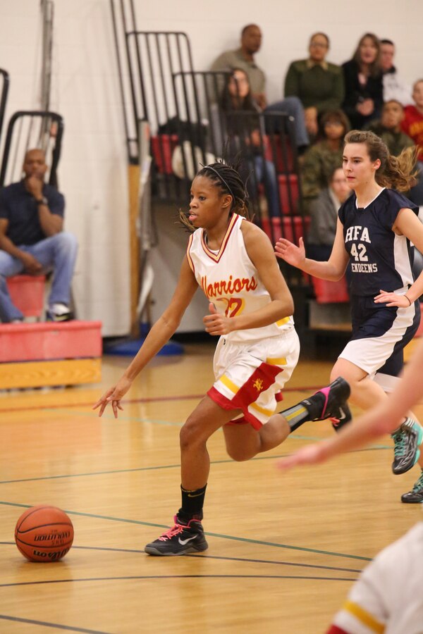 Brittany, a Quantico center, dribbles a ball during a game against the Holy Family Academy Vendeens at Quantico Middle/High School on Jan. 7, 2014. The Lady Warriors finished the game 11 points ahead of their opponent after one round of overtime. 