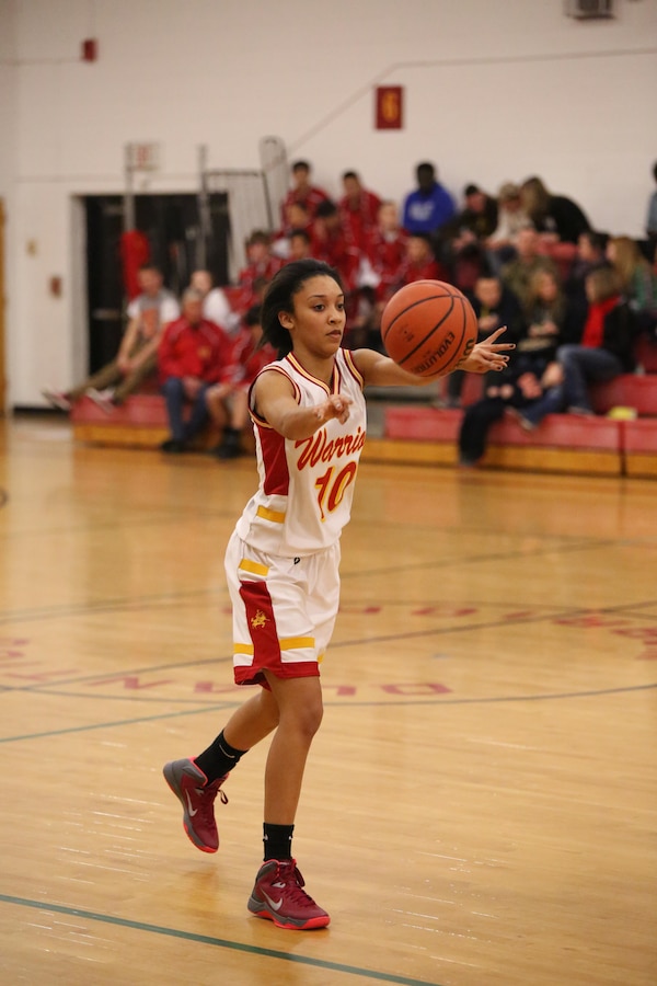 Marquis, a Quantico guard, passes a ball to a teammate during the game against the Holy Family Academy Vendeens at Quantico Middle/High School on Jan. 7, 2014. The Lady Warriors won after one round of overtime. 