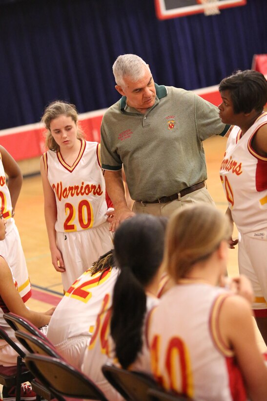 Paul Roy, head coach for the Quantico Varsity Girls’ Basketball Team, talks to players between plays at the Quantico Middle/High School on Jan. 7, 2014. Quantico beat their opponent by 11 points. 