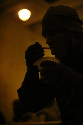 Second Lt. Jonathan Thomsen, student at The Basic School, eats breakfast at Military Operations on Urban Terrain Town aboard Marine Corps Base Quantico on Jan. 10, 2014. The TBS officers ate their meal after finishing their final field exercise before graduation. 