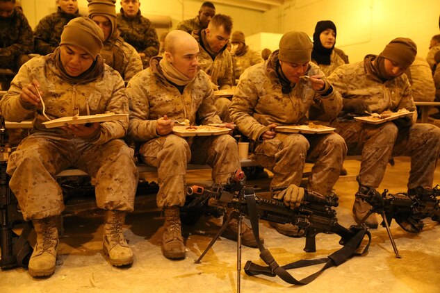 Marines from The Basic School eat a hot breakfast at the end of their final field exercise before graduation at Military Operations on Urban Terrain Town aboard Marine Corps Base Quantico on Jan. 10, 2014. The meal was served by Marine Corps Detachment Fort Lee, Va., food service specialist students. 