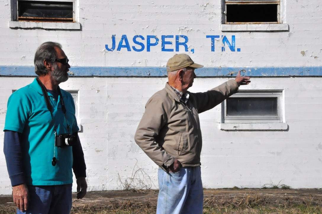 Earl Keeler, 91, (right) retired U.S. Army Corps of Engineers Nashville District lock operator, points to the building at the 100-year-old Hales Bar Dam site where he worked from 1960 until its closing in 1967. At left is the just recently retired Nickajack Lock lockmaster, Butch Witcher, who Keeler helped train at Nickajack Lock in 1980. Witcher arranged the Dec. 19, 2013 visit for his mentor and old friend.
