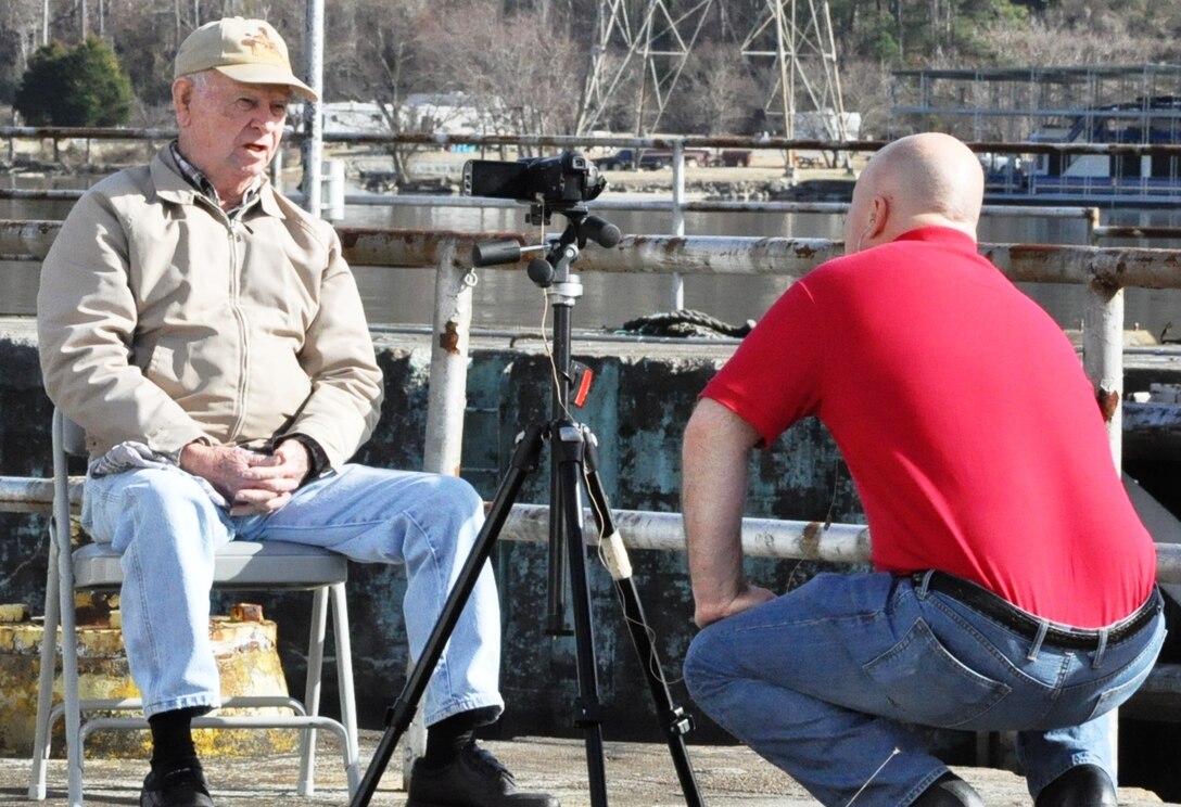 Earl Keeler, 91, (left) retired U.S. Army Corps of Engineers Nashville District lock operator, sits for a videotaped interview Dec. 19, 2013 on the landside of the now closed Hales Bar Lock he operated from 1960 to 1967. Keeler’s visit to the now closed 100-year-old lock was arranged by the just recently retired Nickajack Lock lockmaster, Butch Witcher, who Keeler helped train at Nickajack Lock in 1980.
