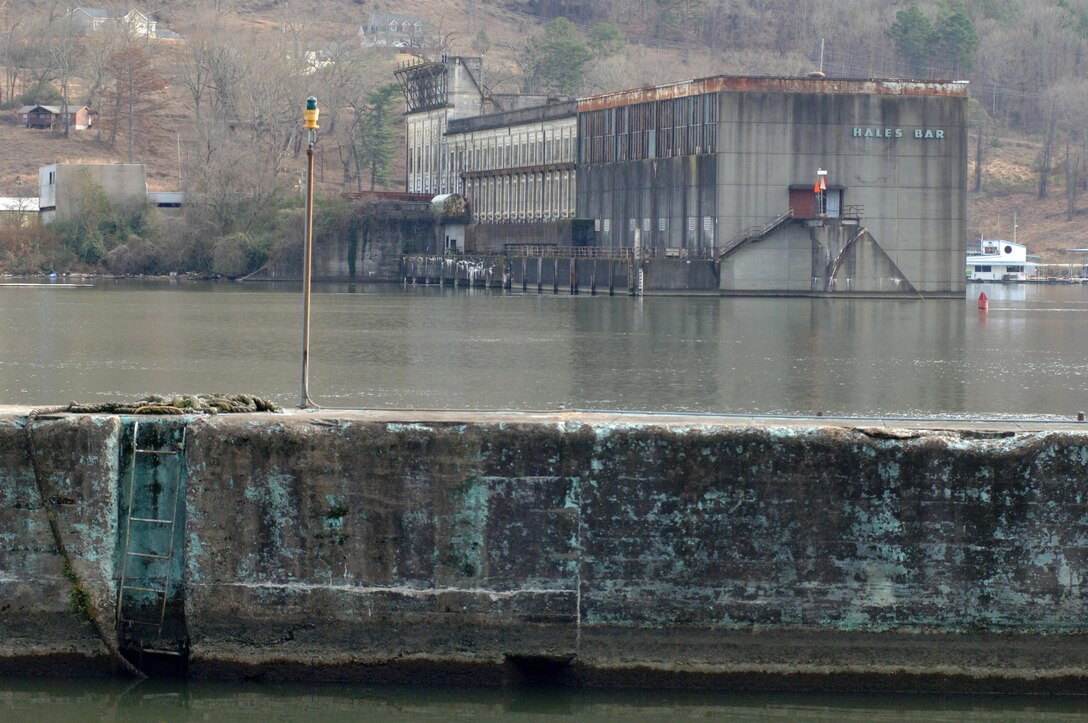 This is the Hales Bar Dam power plant building in Haletown, Tenn., taken from across the Tennessee River at the crumbling navigation lock Dec. 19, 2013 on the bank of the Tennessee River in Jasper, Tenn.  Hales Bar Dam opened in 1913 and the project was the first to provide hydropower in the world. The dam ceased operations in 1968 when Nickajack Dam opened a few miles downstream.  One hundred years later the region looks back and remembers life at Hales Bar Dam and Navigation Lock.