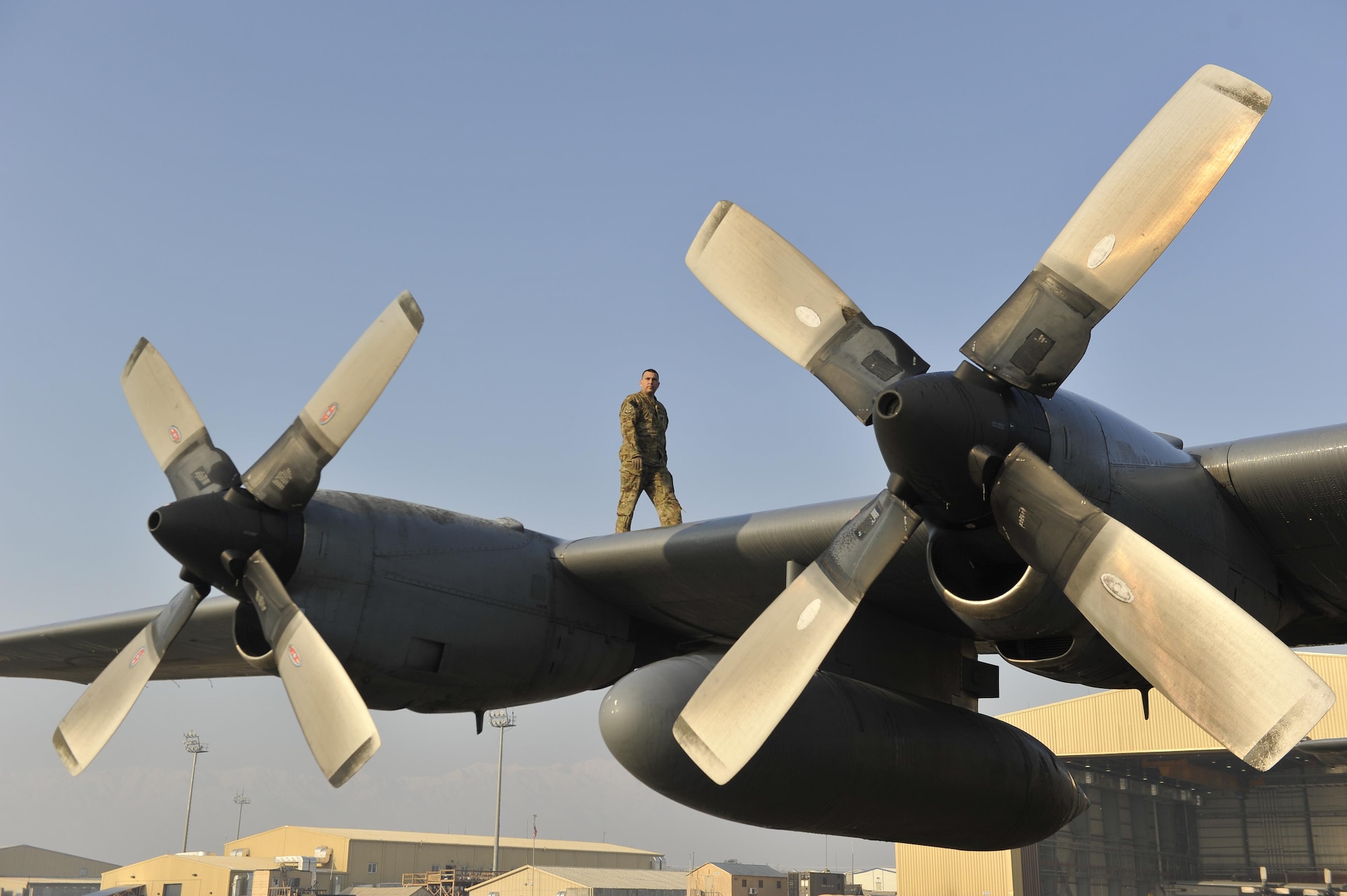 Staff Sgt. David Billings does an inspection of the wings of a C-130H Hercules Jan. 9, 2013, before his flight out of Bagram Airfield, Afghanistan. Billings was on the first of the C-130H model aircraft to permanently relocate out of Bagram to make room for the newer C-130J model aircraft. Billings is a C-130 flight engineer. (U.S. Air Force photo/Senior Master Sgt. Gary J. Rihn)