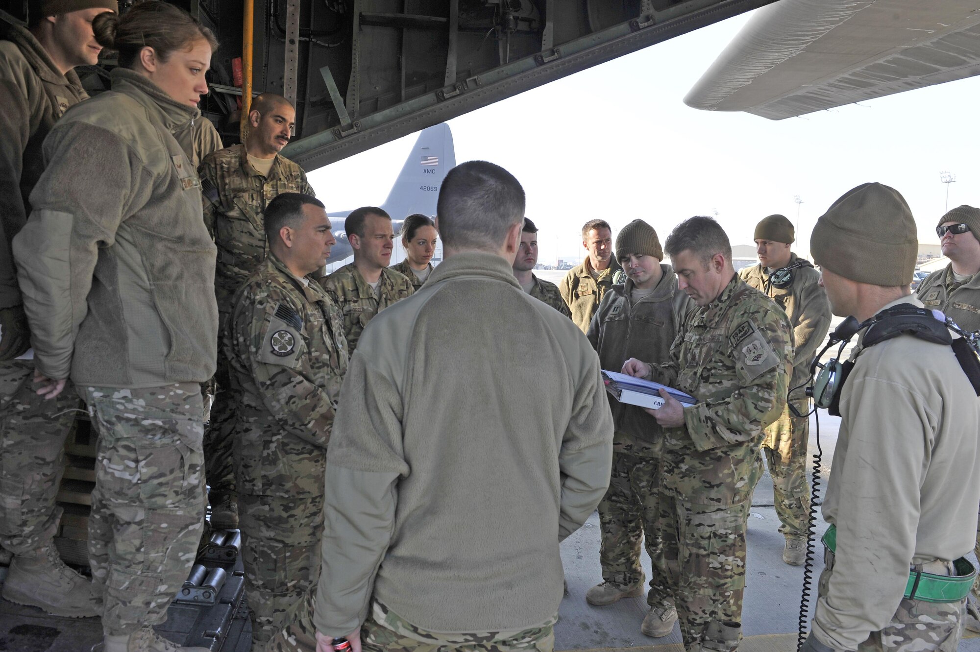 Maj. Kurt Wampole briefs his crew and passengers Jan. 9, 2013, before his flight out of Bagram Airfield, Afghanistan. Wampole was on the first of the C-130H Hercules model aircraft to permanently relocate out of Bagram to make room for the newer C-130J model aircraft. Wampole is a C-130 pilot. (U.S. Air Force photo/Senior Master Sgt. Gary J. Rihn)