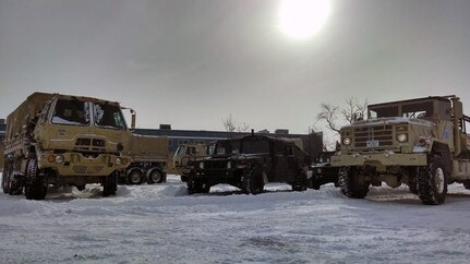 Soldiers of the 1166th Transportation Company from Worcester prepare their LMTVs for tide and flood checks here as part of the Guard’s response to the New Year’s Winter Storm Hercules, Jan. 3, 2014.