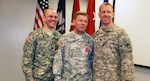U.S. Army Chief Warrant Officer Eric Seymore, the last serving Vietnam War veteran in the South Carolina Army National Guard, celebrates his retirement after 43 years of service, at a retirement ceremony in Columbia, S.C., Jan. 5, 2014. Pictured with Seymore are his sons, 1st Lt. Andrew Seymore and Capt. W. Eric Seymore, who also serve in the South Carolina Army National Guard.