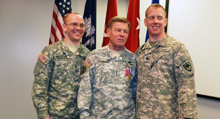 U.S. Army Chief Warrant Officer Eric Seymore, the last serving Vietnam War veteran in the South Carolina Army National Guard, celebrates his retirement after 43 years of service, at a retirement ceremony in Columbia, S.C., Jan. 5, 2014. Pictured with Seymore are his sons, 1st Lt. Andrew Seymore and Capt. W. Eric Seymore, who also serve in the South Carolina Army National Guard.