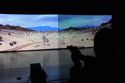 Spc. Brian Muchon, a simulations operator, showcases Fort Indiantown Gap's, marksmanship trainer. The machine allows service members to qualify on assigned weapons including night fire.