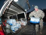 Command Sgt. Maj. Steve Deweese loads water Jan.11, 2014, at the Winfield, W.Va., courthouse. Residents of Kanawha, Boone, Putnam, Lincoln, Logan, Clay, Roane and Jackson counties were told to stop using tap water after a chemical leak contaminated the West Virginia American Water company's system in those areas.
