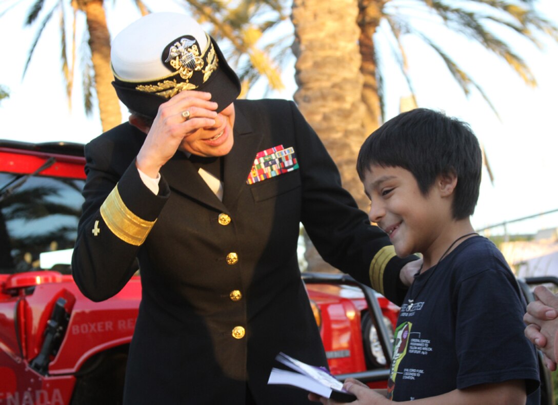 Rear Adm. Margaret Kibbin, the chaplain of the United States Marine Corps, speaks to a Semper Fidelis All-American Bowl attendee during the fan fest before the Semper Fidelis All-American Bowl at The StubHub Center in Carson, Calif., Jan. 5, 2014. Local Marines from the reserve center and recruiting district set up vehicles and booths for the bowl attendees to learn more about the Marine Corps and be entertained before the start of the game. The Semper Fidelis Football Program brought together over 90 of the best high-school football players in an East versus West game and is an opportunity for the Marine Corps to connect on a personal and local level with players and influencers, demonstrates commitment to developing quality citizens, and reinforces how core values of honor, courage and commitment relate to success on and off the field. (Official U.S. Marine Corps photo by Sgt. Dwight A. Henderson/Released)