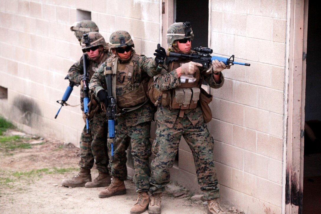 Marines with 2nd Battalion, 1st Marines, prepare to clear a building after throwing a flash bang grenade aboard Camp Pendleton, Calif., Jan. 7. Flash bang grenades emit a flash of light to disorient enemies during a raid.
