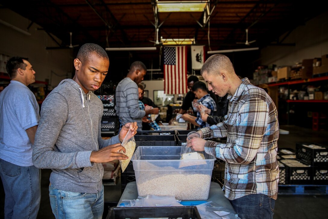 Marines and sailors with the 15th Marine Expeditionary Unit packages bags of oatmeal during a volunteer event at The Angel's Depot in Vista, Calif., Jan. 10, 2014. More than 10 Marines and sailors with the 15th MEU volunteered for the event. (U.S. Marine Corps photo by Cpl. Emmanuel Ramos/Released)