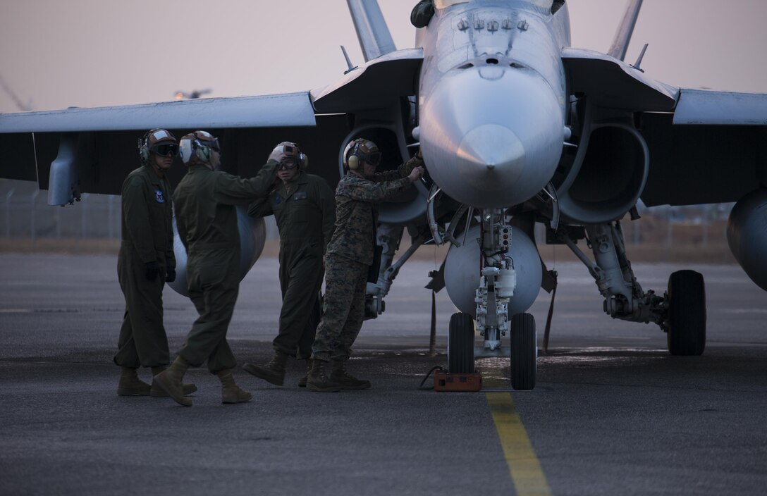 Marines with Marine Fighter Attack Squadron 112, known as the “Cowboys,” preform maintenance checks on F/A-18 Hornets aboard Marine Corps Air Station Iwakuni, Japan, Jan. 8, 2014, to ensure their aircraft meet requirements before they return to Naval Air Station, Joint Reserve Base, Fort Worth, Texas. The squadron has been activated for nine months on a Unit Deployment Program instead of the usual six. They spent three months in Hawaii to receive pre-deployment training prior to being station at MCAS Iwakuni.