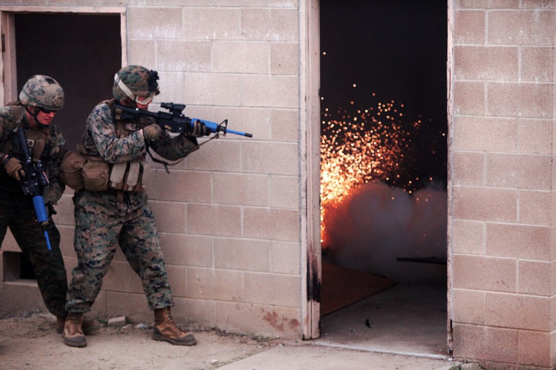 Marines with 2nd Battalion, 1st Marines, prepare to clear a building after throwing a flash bang grenade aboard Camp Pendleton, Calif., Jan. 7. Flash bang grenades emit a flash of light to disorient enemies during a raid.
