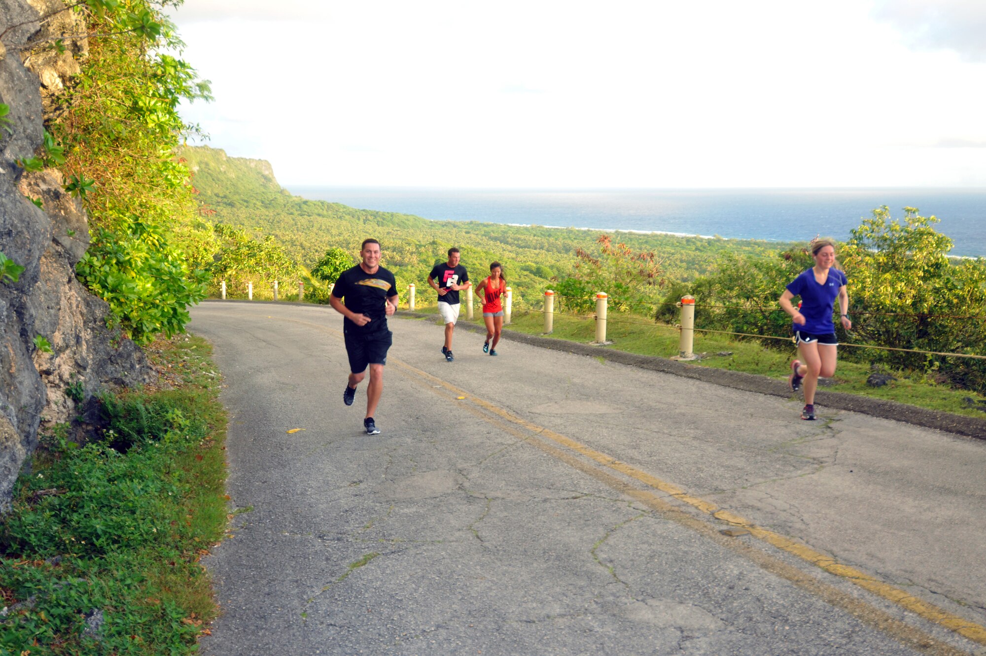 Members of Team Andersen run uphill during the Sanders Slaughter Run, Jan. 14, 2014, on Andersen Air Force Base, Guam.  Approximately 250 participants ran the 4.8 mile distance. (U.S. Air Force photo by Senior Airmen Cierra Presentado/Released)