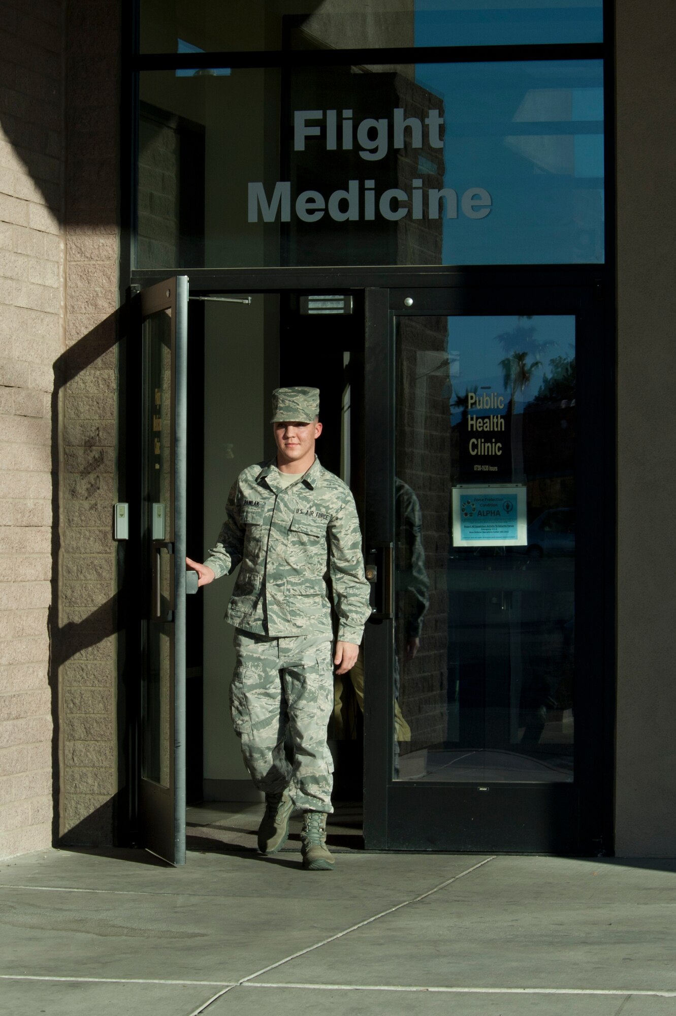 Senior Airman Brandon Pawlak, 99th Aerospace Medicine Squadron public health technician, leaves the Aerospace Medicine clinic Jan. 13, 2014, at Nellis Air Force Base. Nev. The 99th AMDS performs a number of operations ranging from certifying aircrew medically to responding to medical emergencies on the flightline. (U.S. Air Force photo/Airman 1st Class Timothy Young)