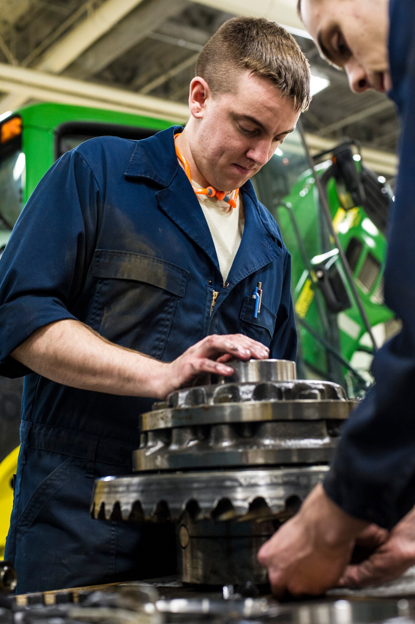 U.S. Air Force Senior Airman Anthony Tavares and Airman 1st Class Mitch Whitman, 354th Logistics Readiness Squadron vehicle maintenance flight, disassemble a differential from a flightline snow broom Jan. 9, 2014, Eielson Air Force Base, Alaska. The flightline snow broom is critical to the 354th Fighter Wing mission during the harsh winter months. (U.S. Air Force photo by Senior Airman Joshua Turner/Released)
