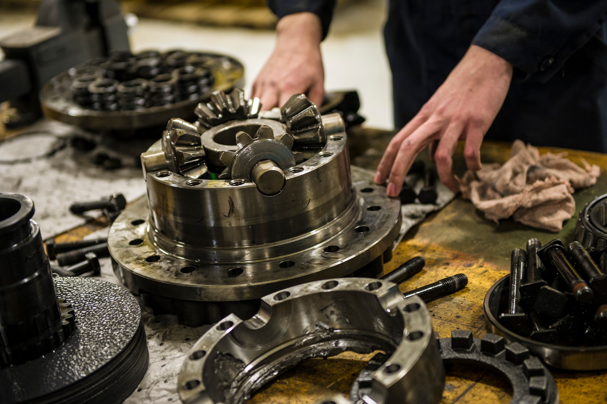 U.S. Air Force Airman 1st Class Mitch Whitman, 354th Logistics Readiness Squadron vehicle maintenance apprentice, prepares to remove gears from a snow broom differential Jan. 9, 2014, Eielson Air Force Base, Alaska. A differential allows a pair of wheels to rotate at different speeds. (U.S. Air Force photo by Senior Airman Joshua Turner/Released)