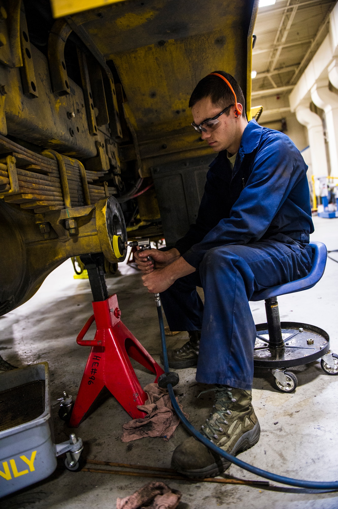 U.S. Air Force Airman 1st Class Mitch Whitman, 354th Logistics Readiness Squadron vehicle maintenance apprentice, cleans the front axle housing of a flightline snow broom Jan. 8, 2014, Eielson Air Force Base, Alaska. The flightline snow broom is critical to the 354th Fighter Wing mission during harsh Alaskan winter months. (U.S. Air Force photo by Senior Airman Joshua Turner/Released)