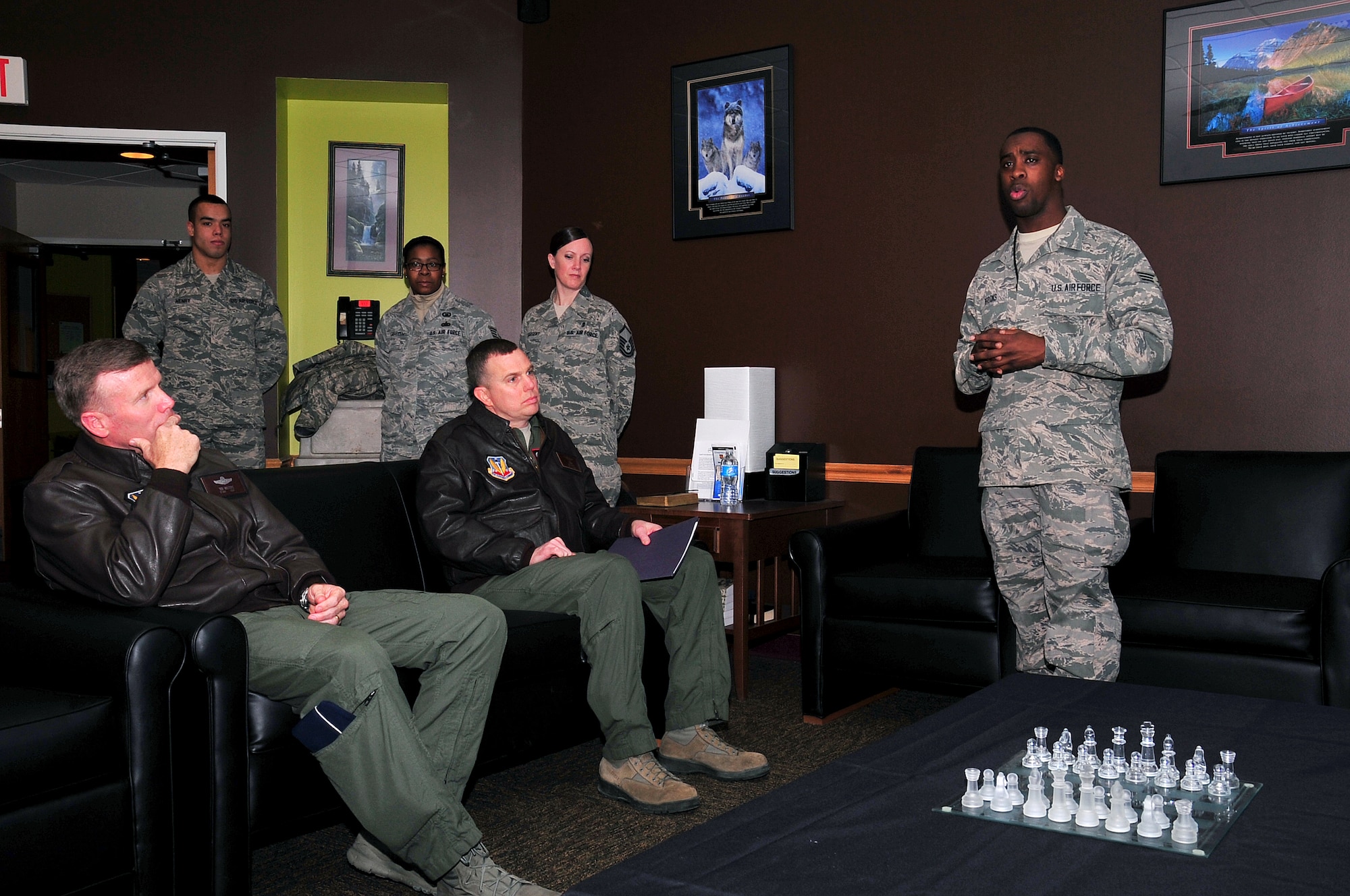 U.S. Air Force Senior Airman Trevon L. Brooks briefs U.S. Air Force Lt. Gen. Tod D. Wolters, 12th Air Force (AFSOUTH) commander (seated, left) on what the base chapel does in support of local airmen. The general toured Tuskegee Hall on Offutt Air Force Base Jan. 9. along with U.S. Air Force Col. Gregory M. Guillot,  55th Wing commander (seated, right). (U.S. Air Force photo by D.P. Heard/Released)
