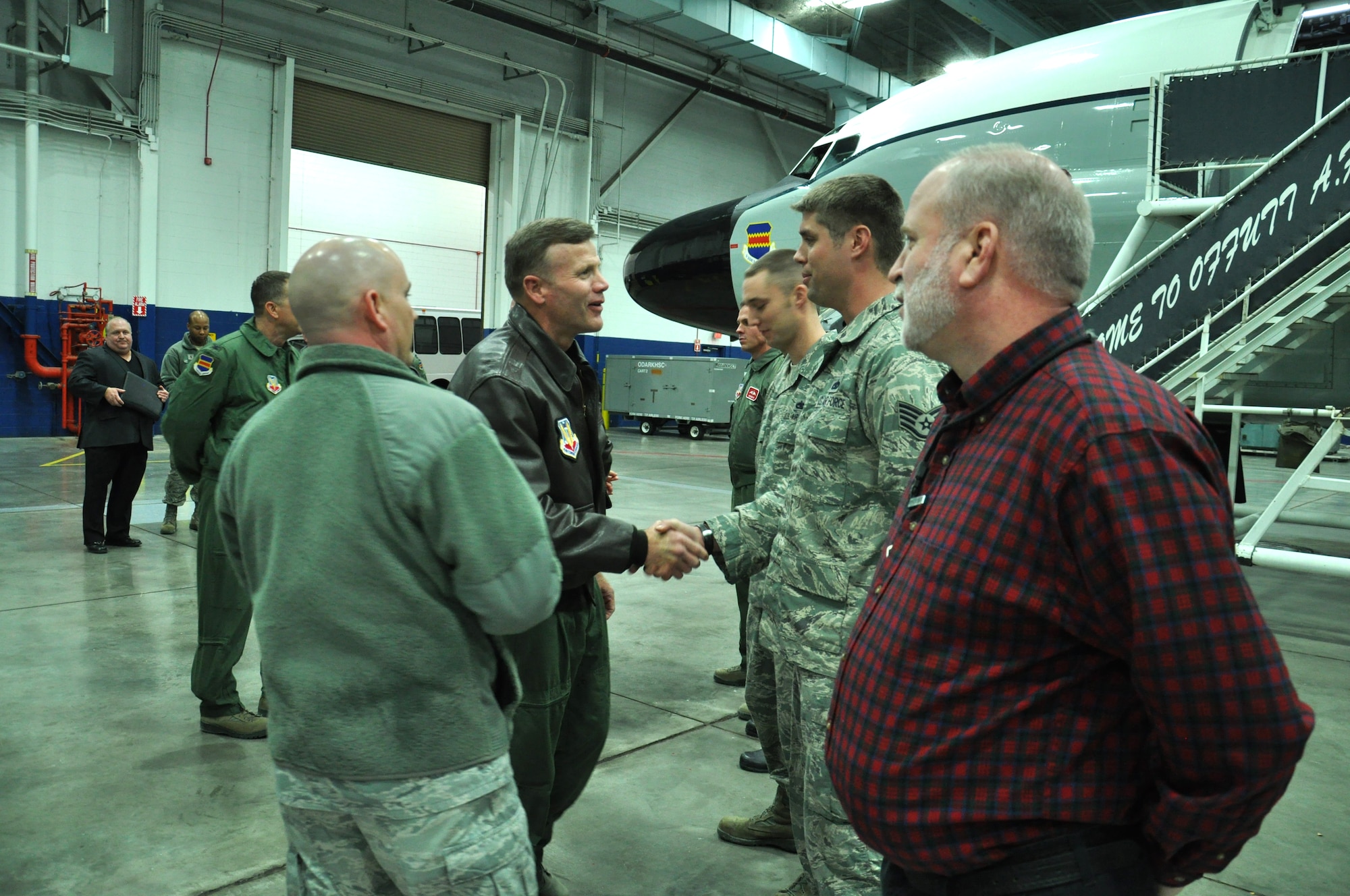 U.S. Air Force Lt. Gen. Tod Wolters, 12th Air Force (AFSOUTH) commander, shakes hands with U.S. Air Force Staff Sgt. Adam Bowers, 55th Aircraft Maintenance Squadron and Rivet Joint crew chief, before receiving a tour of the jet on Jan. 8 at the Bennie Davis Maintenance Facility on Offutt Air Force Base, Neb. This is Wolters' first visit to Offutt after taking command of the 12th Air Force in September. (U.S. Air Force photo by 2nd Lt. Carly Costello/Released)
