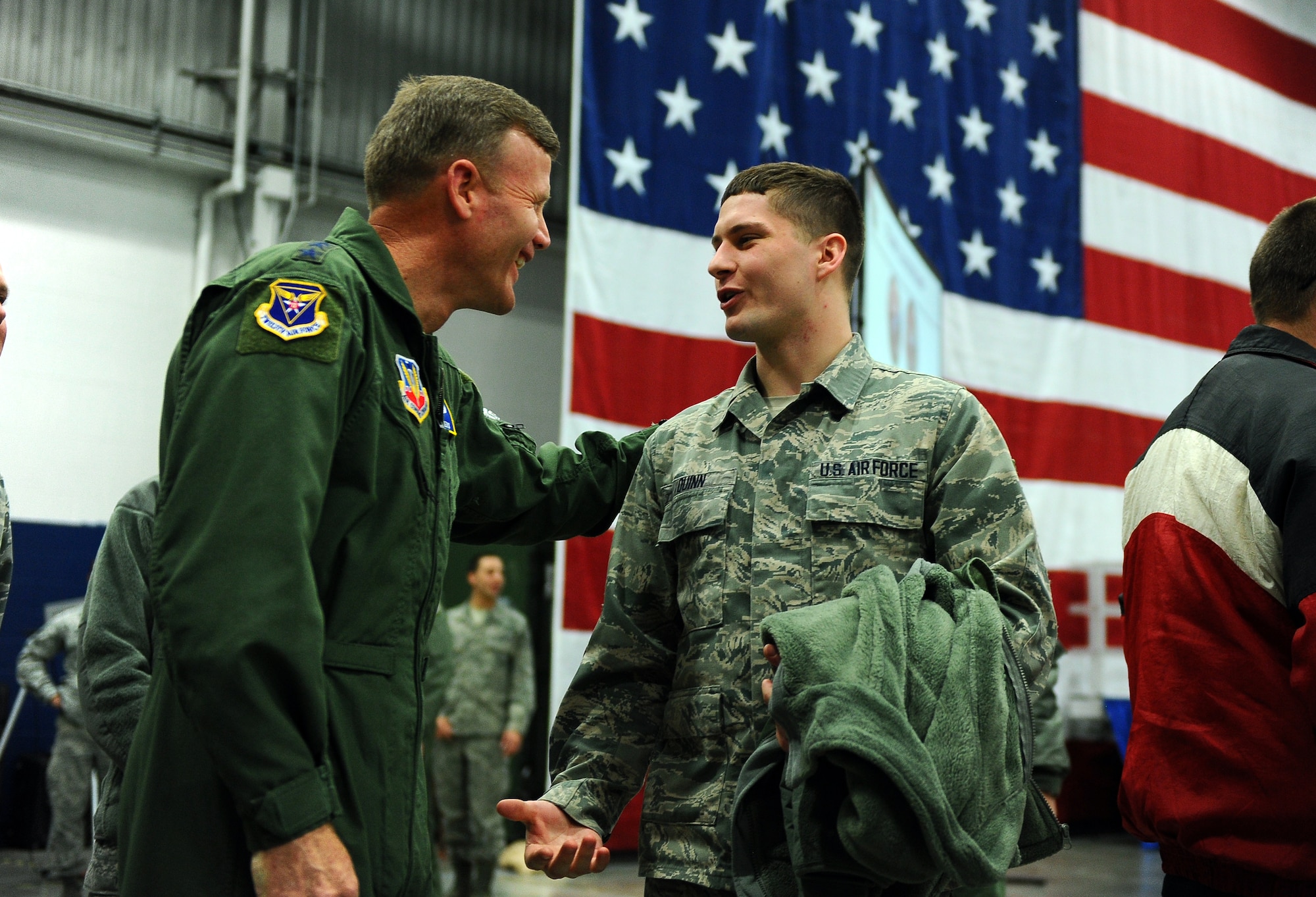 U.S. Air Force Lt. Gen. Tod D. Wolters, 12th AF (AFSOUTH) commander, meets with U.S. Air Force Airman 1st Class Cameron Quinn, assigned to the 55th Intelligence Support Squadron, following his all call briefing held in Dock 1 of the Bennie Davis Maintenance Facility on Jan 9 at Offutt Air Force Base, Neb.  Several Airmen waited to meet with the commander following his briefing.  (U.S. Air Force photo by Josh Plueger/Released)