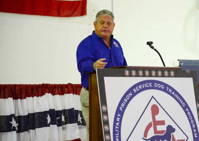 Rick Hairston, co-founder, president and CEO of the Carolina Canines for Service program, gives a speech Jan. 9, 2014, during a ceremony at the Naval Consolidated Brig Charleston at Joint Base Charleston – Weapons Station. CCFS is a non-profit health and human services organization that trains service dogs for veterans with disabilities. (U.S. Air Force photo/Airman 1st Class Clayton Cupit)