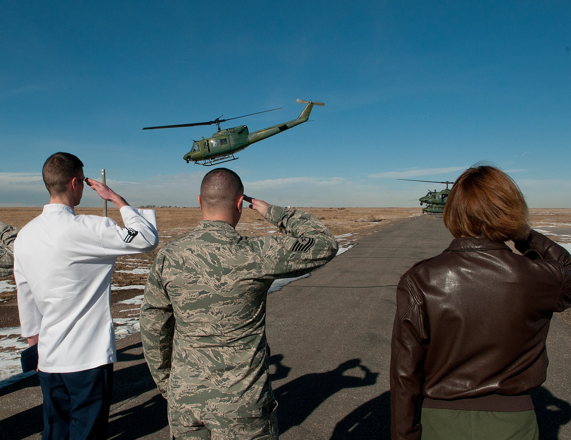 Members of the 319th Missile Squadron salute as U.S. Defense Secretary Chuck Hagel departs Missile Alert Facility E-01 in Kimball County, Neb., Jan. 9, 2014, on a UH-1N "Huey" from the 37th Helicopter Squadron. Hagel visited F.E. Warren Air Force Base, Wyo., and the 90th MW to learn about the ICBM mission and the people who operate, maintain, secure and support the Minuteman III weapon system. (U.S. Air Force photo by R.J. Oriez)