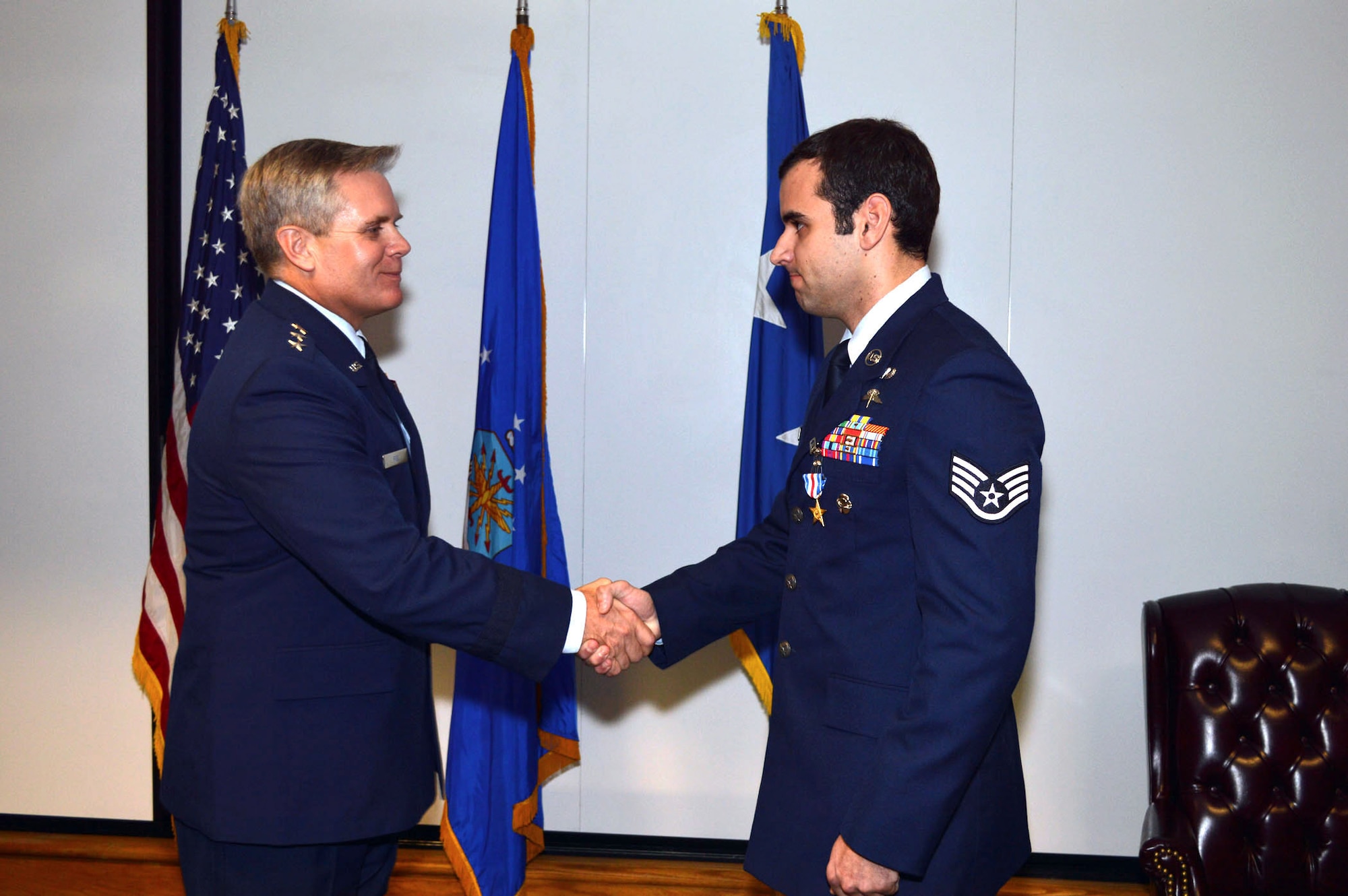 Lt. Gen. Eric Fiel, Air Force Special Operations Command commander, awards the Silver Star medal to Staff Sgt. Christopher Baradat, 21st Special Tactics Squadron, Jan. 10, 2014, Pope Army Airfield, Fort Bragg, N.C., for heroically distinguishing himself by gallantry in connection with military operations against an armed enemy of the United States in Sono Valley, Sheltan District, Kunar Province, Afghanistan, April 6, 2013. (U.S. Air Force photo by Marvin Krause)