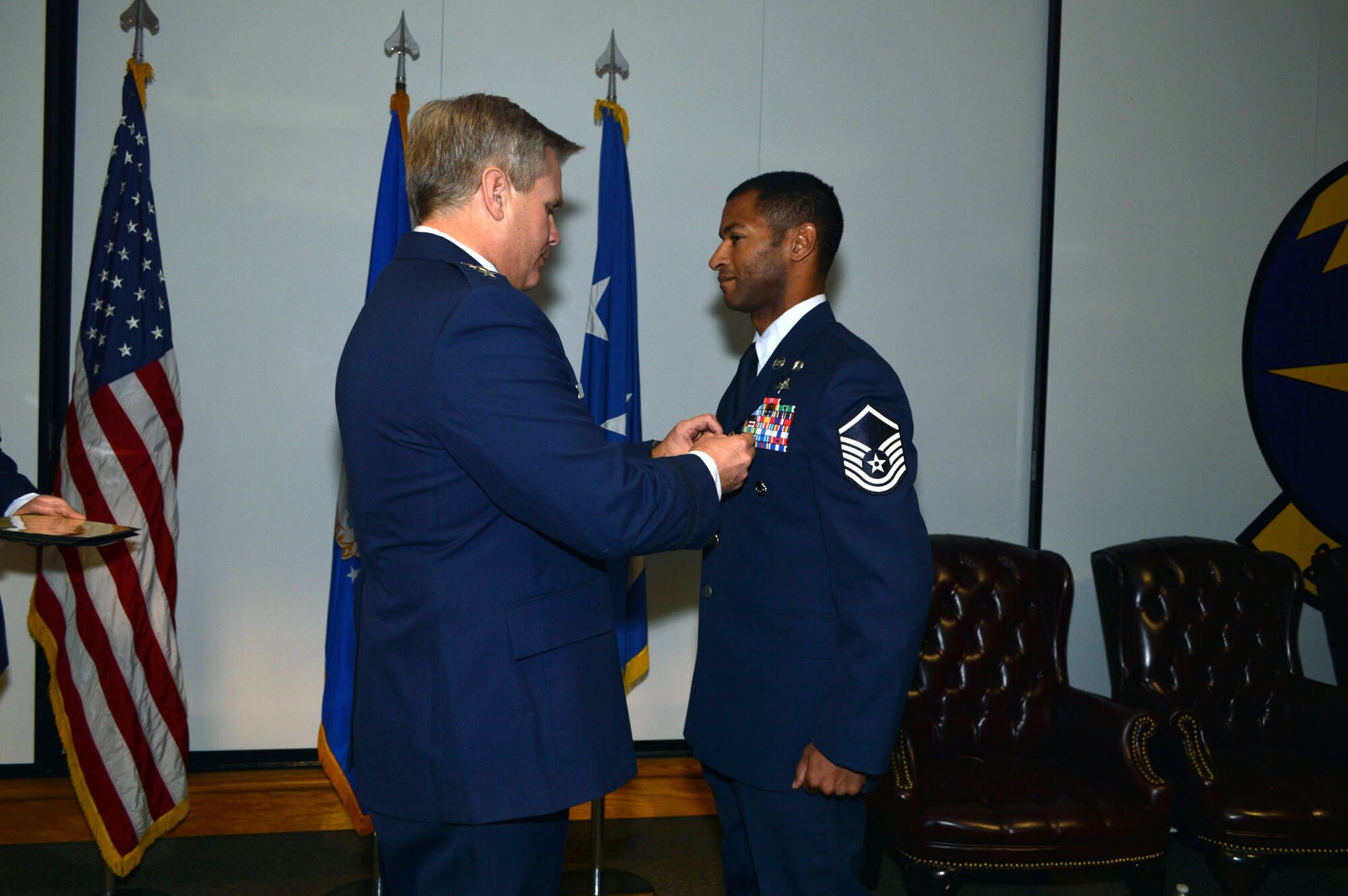 Lt. Gen. Eric Fiel, Air Force Special Operations Command commander, awards the Silver Star medal to Master Sgt. Delorean Sheridan, 21st Special Tactics Squadron, Jan. 10, 2014, at Pope Army Airfield, Fort Bragg, N.C., for heroically distinguishing himself by gallantry in connection with military operations against an armed enemy of the United States in Wardak Province, Afghanistan, March 11, 2013. (U.S. Air Force photo by Marvin Krause)