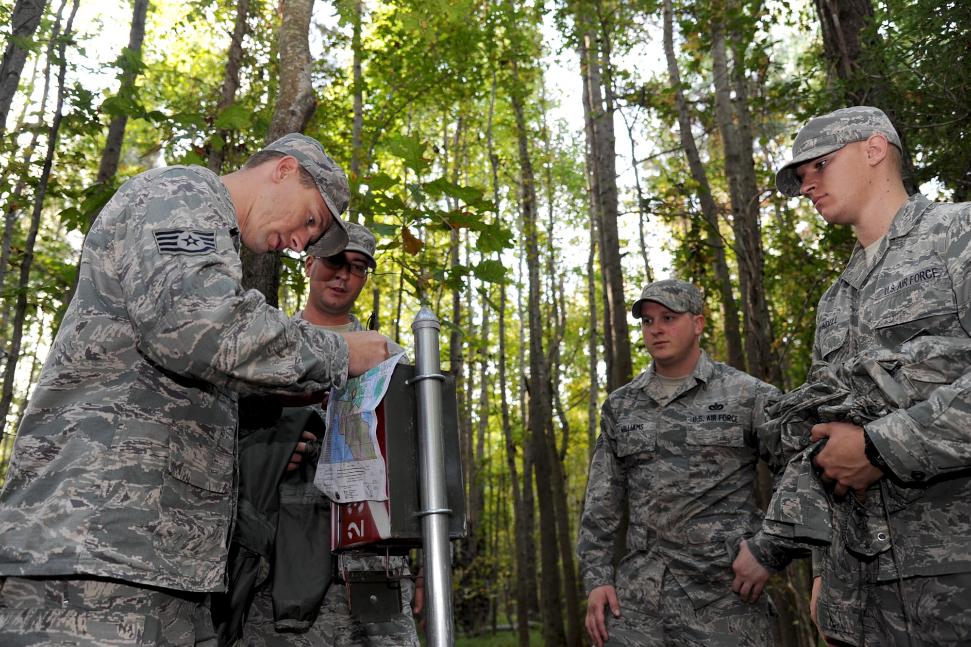U.S. Air Force Airmen from the 633rd Civil Engineer Squadron Prime Base Emergency Engineer Force (BEEF) discover a marker during land navigation training at Fort Eustis, Va., Oct. 16, 2013. In addition to land navigation areas, Fort Eustis offers beachheads, cargo loading zones and numerous specialized ranges and buildings for training. (U.S. Air Force photo by Airman 1st Class Austin Harvill/Released)