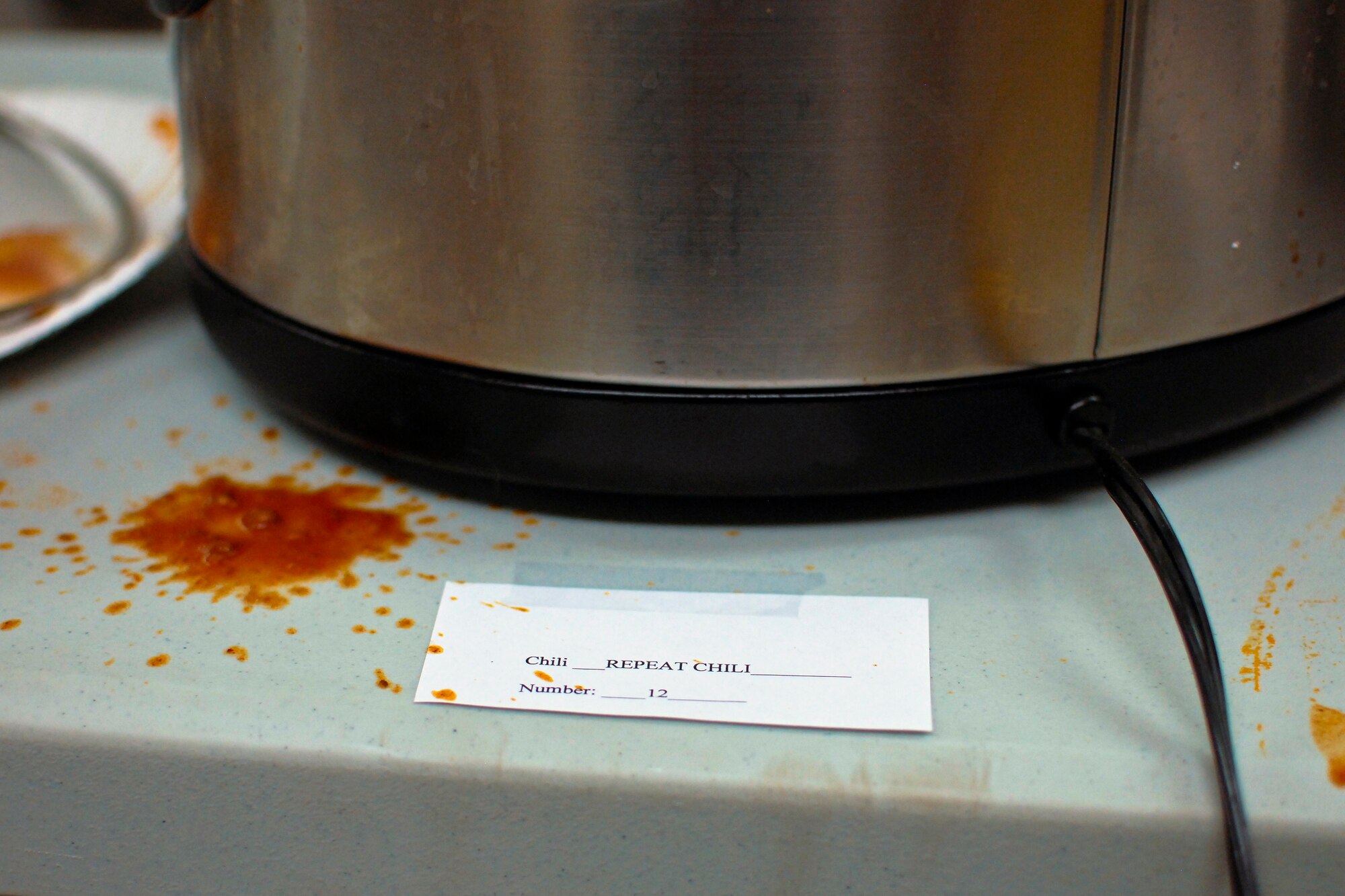 The aftermath of U.S. Air Force Master Sgt. Ian Berhringer’s Repeat Chili is seen after the sixth-annual chili cook off at the 182nd Airlift Wing, Peoria, Ill., Jan. 8, 2014. The competition placed 13 contestants and their homemade chili recipes against each other to compete for best look and smell, best consistency, and best taste. Behringer, a guidance and control shop chief with the Maintenance Squadron, won in the best taste category and the people’s choice award for his recipe. The event brought out approximately 120 unit members to sample the various white and traditional red entries, and raised $490 in support of operating the wing’s consolidated club. (U.S. Air National Guard photo by Staff Sgt. Lealan Buehrer/Released)