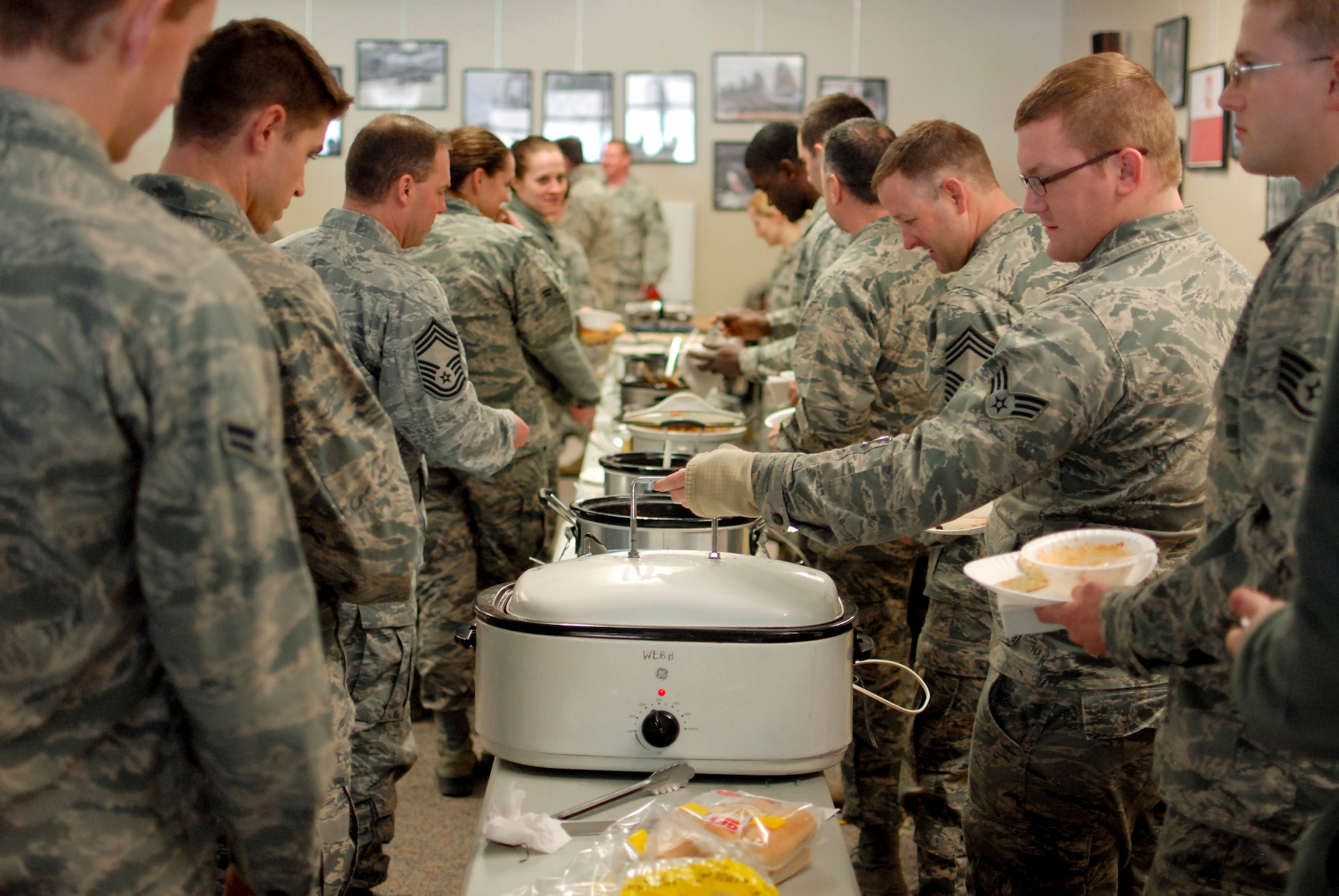 Airmen of the 182nd Airlift Wing sample chili during the sixth-annual chili cook off at the 182nd Airlift Wing, Peoria, Ill., Jan. 8, 2014. The competition placed 13 contestants and their homemade chili recipes against each other to compete for best look and smell, best consistency, and best taste. The event brought out approximately 120 unit members to sample the various white and traditional red entries, and raised $490 in support of operating the wing’s consolidated club. U.S. Air Force Tech. Sgt. Alex R. Sea, vehicle equipment maintenance specialist and winner of the 2014 competition, enjoys the yearly event because he gets to have good chili with good people, he said. “It’s a good way to get out and mingle and talk to the people you don’t usually see on a day-to-day basis.” (U.S. Air National Guard photo by Staff Sgt. Lealan Buehrer/Released)