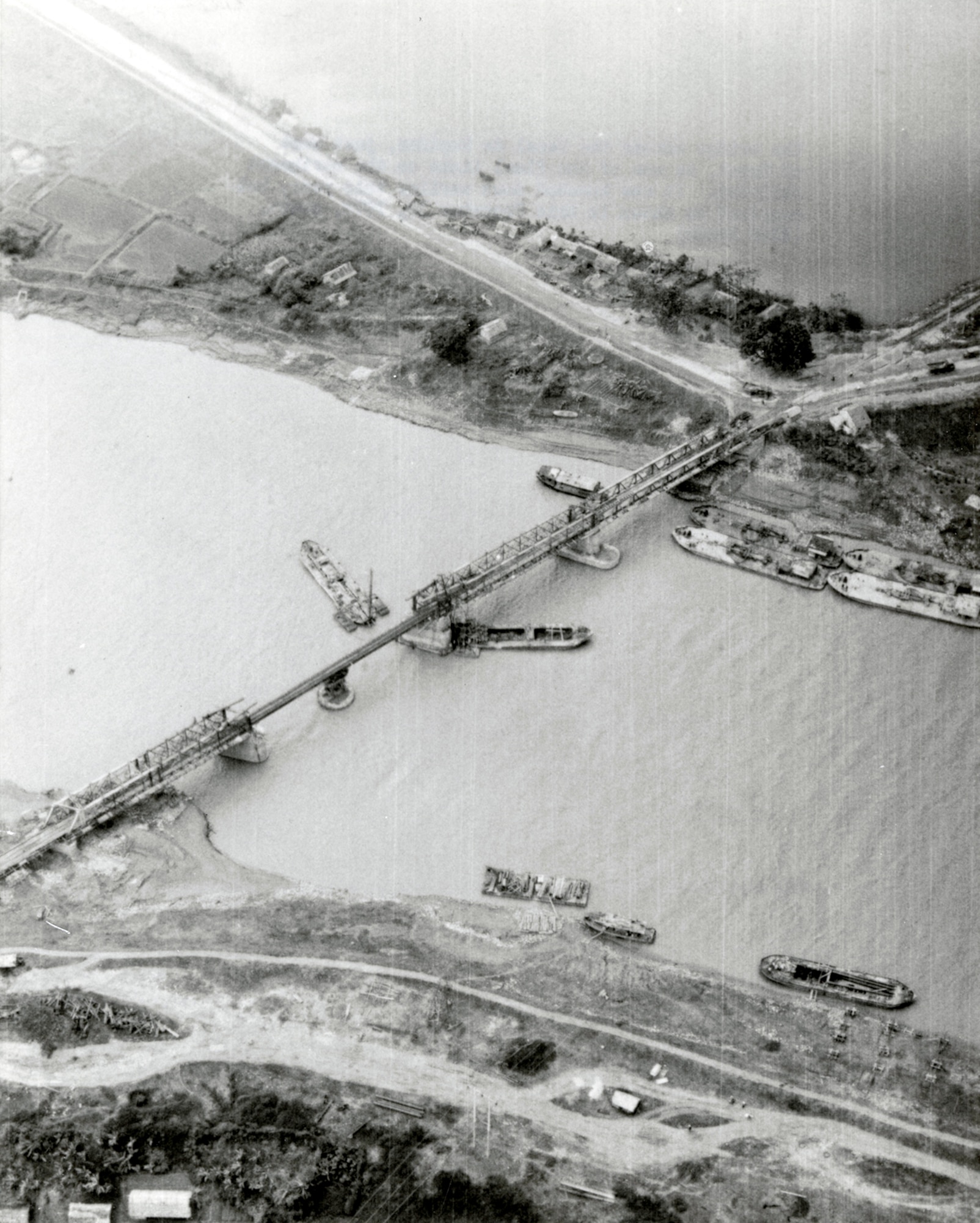 Enemy activity required constant monitoring. This December 1972 photo shows repairs to an important bridge just east of Hanoi, North Vietnam. It had been bombed earlier that year. (U.S. Air Force photo)