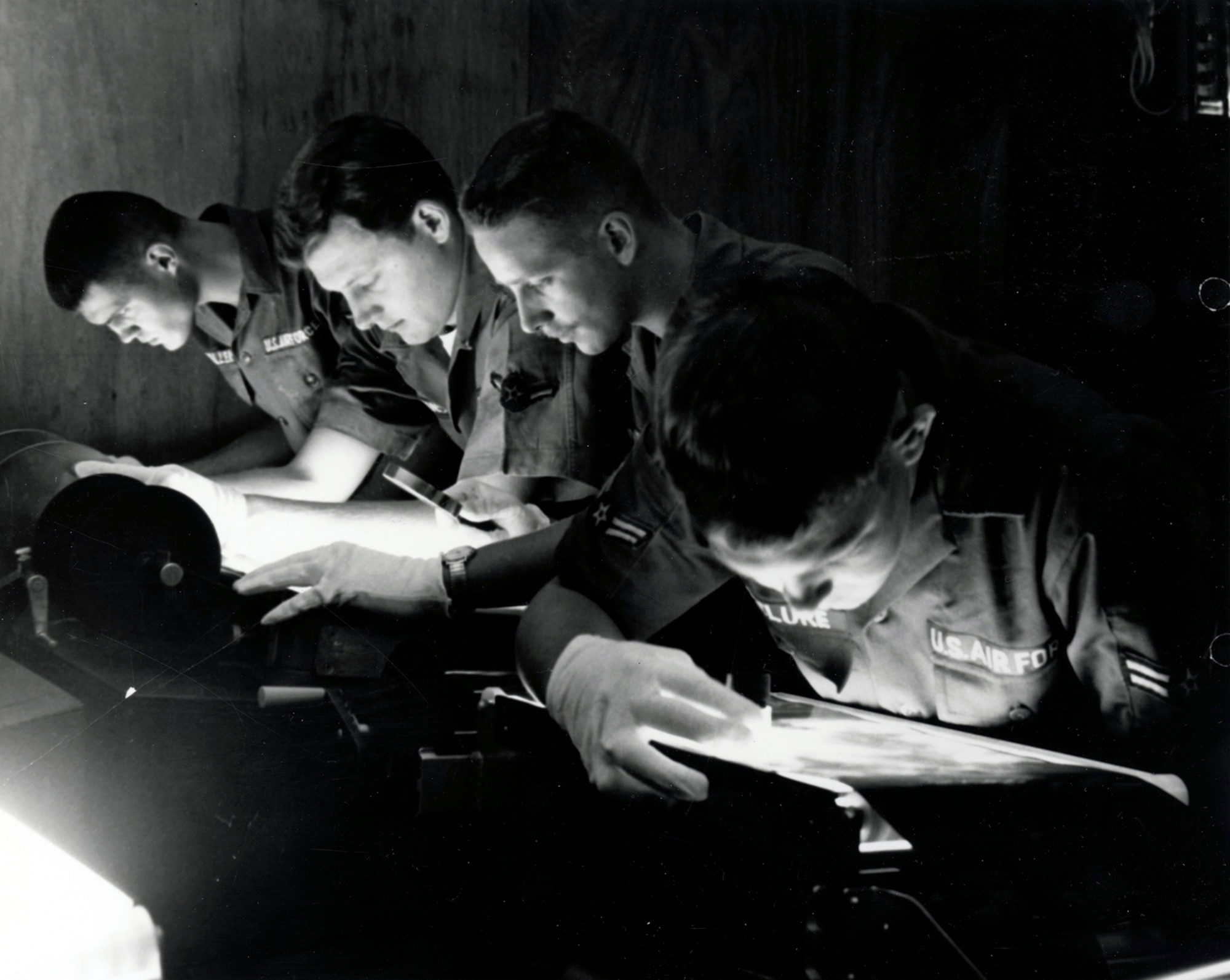 Photo interpreters carefully analyzed reconnaissance images. Using highly-specialized knowledge and skills, they provided valuable intelligence about enemy activities and threats. (U.S. Air Force photo)