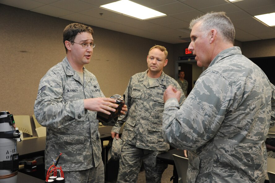 Senior Airman James McKinney, 927th Security Forces Squadron, shows Brig. Gen. John Flournoy, 4th Air Force Commander, and Col. Brad Anderson, 927th Air Refueling Wing vice commander, various inert improvised explosive devices maintained by the 927th SFS supply section at MacDill Air Force Base, Fla., Jan. 14, 2014.  These inert devices are used by the 927th Security Forces Airmen for training purposes.  (U.S. Air Force photo by Staff Sgt. Jennie Chamberlin)