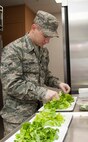 Airman Brett Albright, 742th Missile Squadron missile chef, prepares salads at a Minot Air Force Base missile alert facility, Dec. 14, 2013. Through their cooking, missile chefs boost morale and create a sense of home for Airmen who work in the field. (U.S. Air Force photo/Airman 1st Class Andrew Crawford)