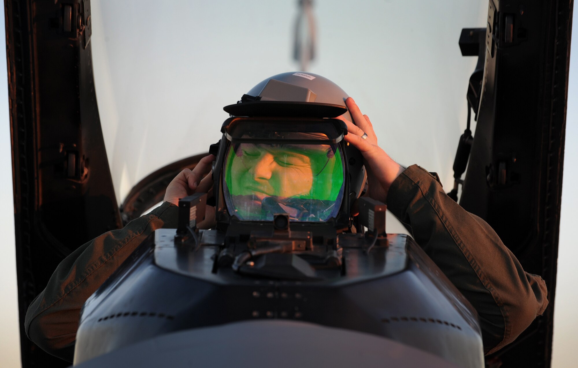 Capt. Matthew Sabraw, 555th Fighter Squadron pilot, puts on his helmet before a takeoff, Dec. 5, 2013, at Aviano Air Base, Italy. The number one priority for the Triple Nickel and 510th Fighter Squadrons is combat mission readiness, which is in-line with the 31st Fighter Wing’s mission; combat air power: anytime, anywhere. (U.S. Air Force photo/Senior Airman Matthew Lotz)