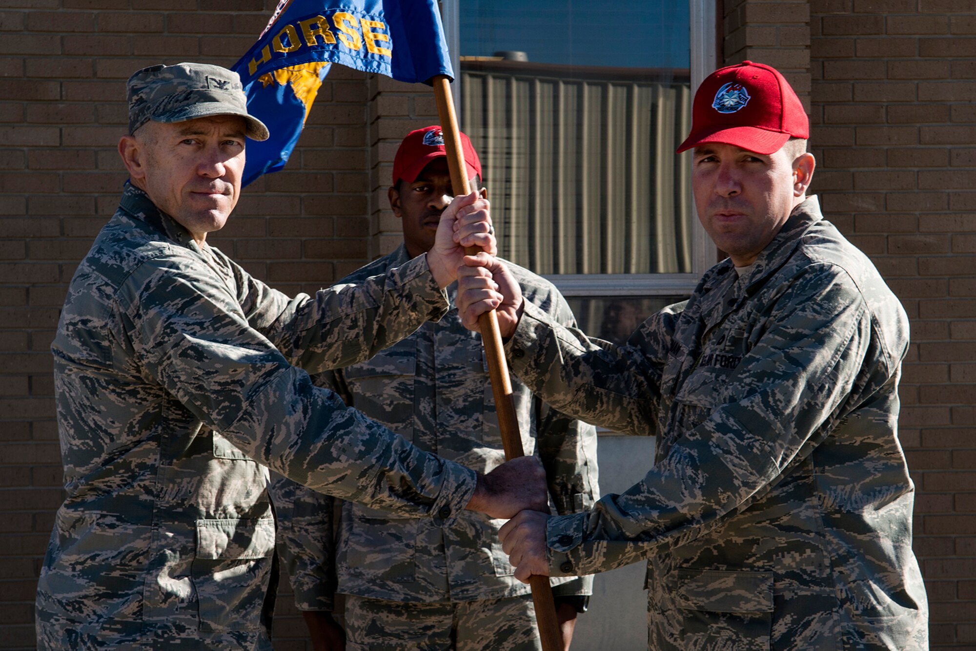 U.S. Air Force Col. Timothy Lamb (left), 622nd Civil Engineer Group commander, presents the 307th Rapid Engineer Deployable Heavy Operational Repair Squadron Engineers (RED HORSE) guidon to Lt. Col. Charles Chapman III during an Assumption of Command ceremony, Jan. 12, 2014, Barksdale Air Force Base, La. Red Horse squadrons provide the Air Force with a highly mobile civil engineering response to support contingency and special operations worldwide. (U.S. Air Force photo by Master Sgt. Greg Steele/Released)