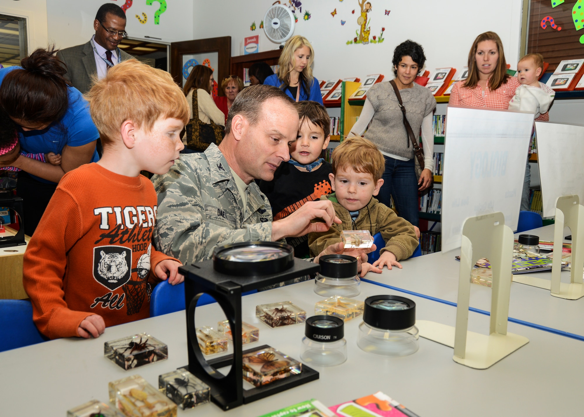 Col. Daniel Daetz (center), 412th Test Wing vice commander shows an insect sample to the children attending the grand opening of the new STEM Science Discovery Center at the Base Library Jan. 10. (U.S. Air Force photo by Rebecca Amber)