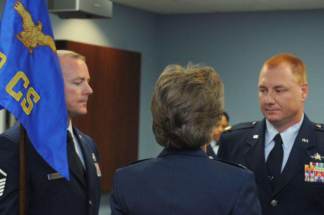 U.S. Air Force Reserve Major Thaddeus “Ted” Janicki, commander of the 910th Communications Squadron here, faces U.S. Air Force Reserve  Colonel Teresa Hams, commander of the 910th Mission Support Group during the exchange of the squadron flag, Jan. 12, 2014. Janicki assumed command of the Communications Squadron during the January drill weekend. (U.S. Air Force photo/Senior Airman Rachel Kocin)